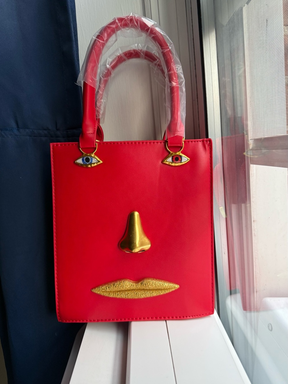 Women's Red Novelty Face Tote Bag with Gold Accents